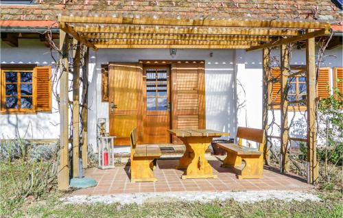 a picnic table and benches on a brick patio at Kellerstoeckl In Strem in Sumetendorf