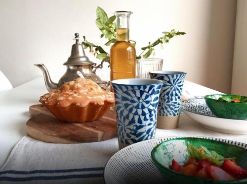 a table with bowls of food and a bottle of wine at Xokoan in Biarritz