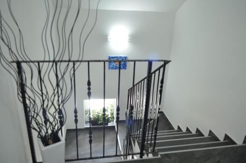 a stairway with a black metal railing and stairs at Katarica in Korenica