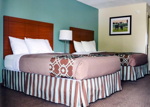 two beds sitting next to each other in a hotel room at SureStay Hotel by Best Western Bowling Green North in Bowling Green