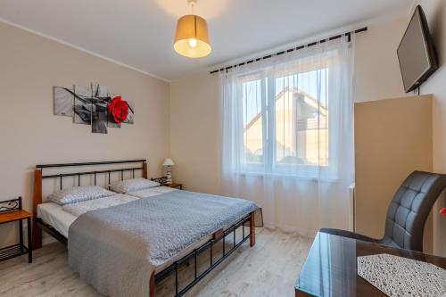 a bedroom with a bed and a window at Camelot in Łeba