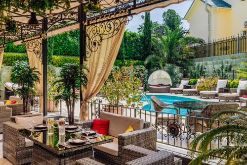 a patio with a table and chairs and a pool at GREEN HOUSE Detox & SPA Hotel in Sochi