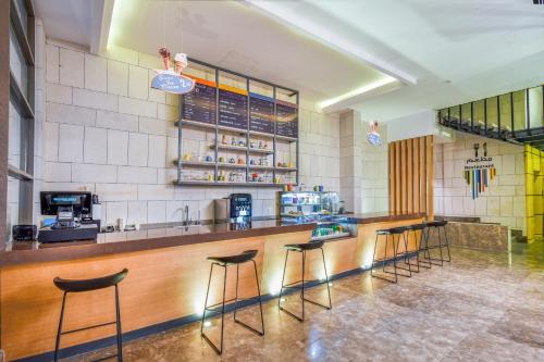 a bar in a restaurant with stools at a counter at Ewaa Express Hotel - Khurais in Riyadh