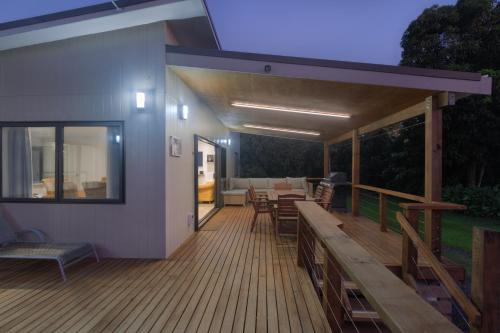 a large deck with a table and chairs on it at Inn Land Inn in Vaimaanga