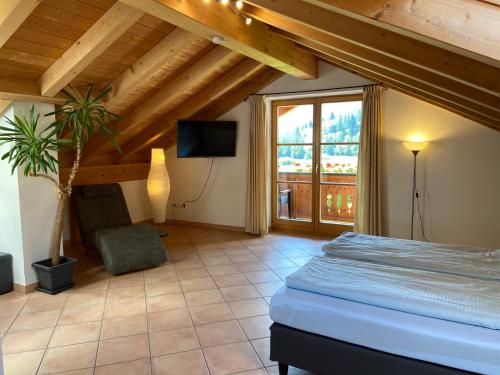 a bedroom with a bed and a large window at Ferienwohnung Bergblick für 10 Personen in Unterammergau