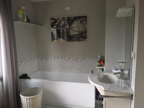 een badkamer met een bad en een wastafel bij I tulipani flat in bedizzol