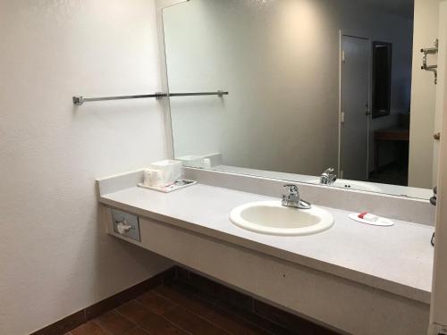 a bathroom with a sink and a mirror at Travelodge by Wyndham Truth or Consequences in Truth or Consequences