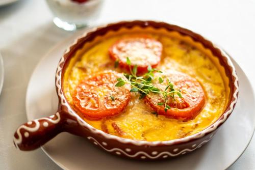 a bowl of food on a plate on a table at Willa Krakowska in Raszyn