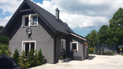 a gray house with a black roof at Agroturystyka,, Ranczo Kruszynki" in Stronie Śląskie