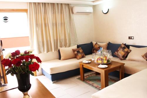 a living room with a couch and a table at Hotel Club Almoggar Garden Beach in Agadir