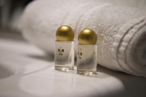 two bottles of medicine sitting next to towels at Garni Hotel Wildanger in Zöblen