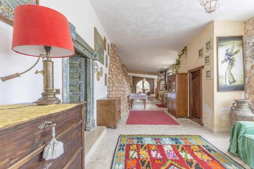 a living room with a red lamp on a table at Villa Aurora in Torre Vado