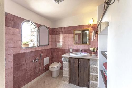 a bathroom with a toilet and a sink at Villa Aurora in Torre Vado