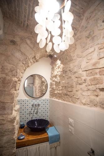 a bathroom with a sink and a chandelier at LA VIOLA.2 in Assisi