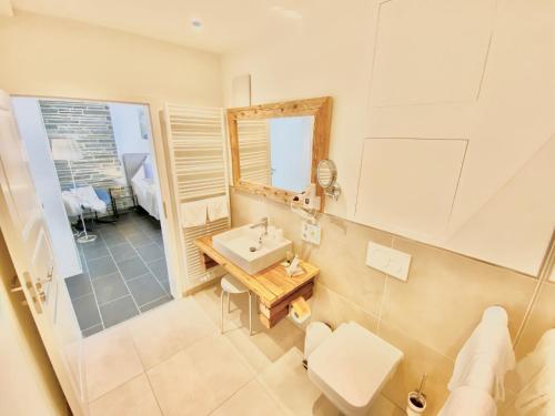 a bathroom with a sink and a mirror at JUULS - Natur Hotel Garni in Simmerath