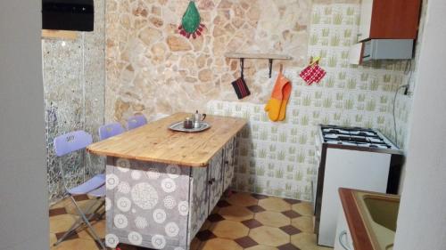 a kitchen with a table and a stove in it at Vista mare in Torre Lapillo