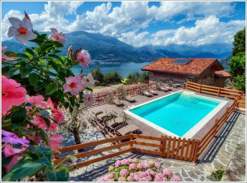a villa with a swimming pool and a view of a lake at Fantastica Casa Poppo in Bellano