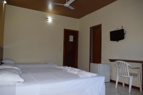 Ένα ή περισσότερα κρεβάτια σε δωμάτιο στο Duas Praias Hotel Pousada