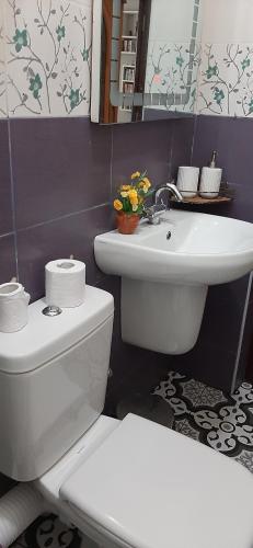 a bathroom with a white toilet and a sink at FUFA Haute standing appartment S2 center Monastir in Monastir
