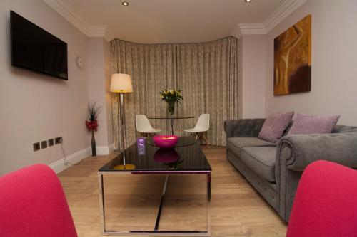 a living room with a couch and a table at Harrogate Lifestyle Luxury Serviced ApartHotel in Harrogate