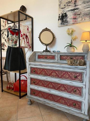 a dresser with a mirror on top of it at Canduleri in Orgosolo