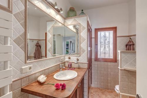 a bathroom with a sink and a mirror at Casa Paqui in Port de Soller