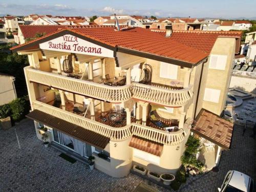 an aerial view of a building with aitating tiled roof at Apartments Rustika Toscana in Vodice