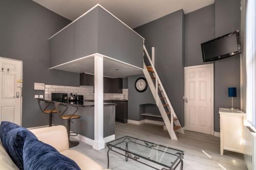 a living room with a kitchen and a staircase in the ceiling at 1 Bed Old Town City Studio near Theatre Suit Work or Leisure in Hull