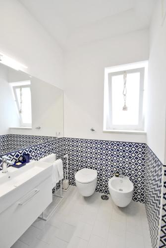 a bathroom with a toilet and a sink at Carthusia Suites in Capri