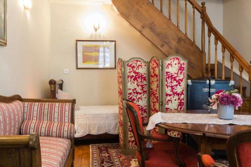a living room with a couch and a table at Chambre d'hôtes Le Petit Tertre in Dijon