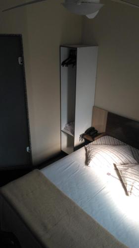 a bedroom with a large bed and a mirror at Hotel Vilamoura in Sao Paulo