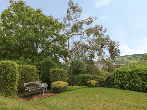 a bench sitting in the middle of a garden at The Old Vicarage in Tiverton