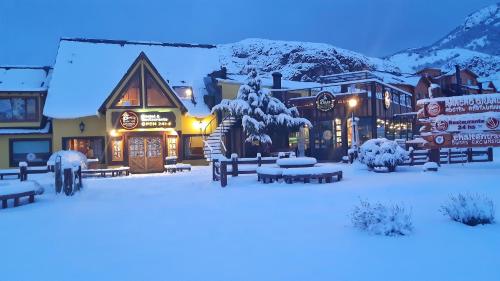 a town covered in snow at night at Rancho Grande Hostel in El Chalten