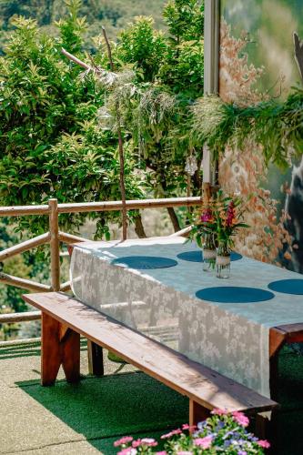 a wooden bench sitting next to a table at Tea House Gerês - T1 Hipericão in Geres