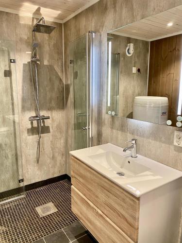 a bathroom with a sink and a shower at Korgfjellet Fjellstue as in Korgen