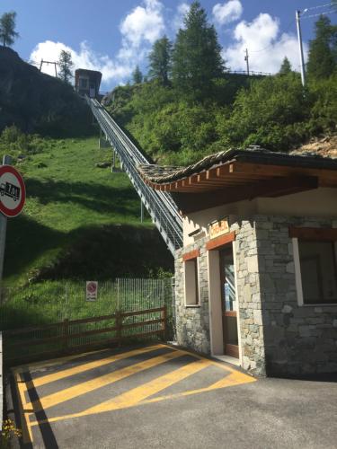 a stairway leading up to a building with a hill at CHALET GORRET CHENEIL in Valtournenche