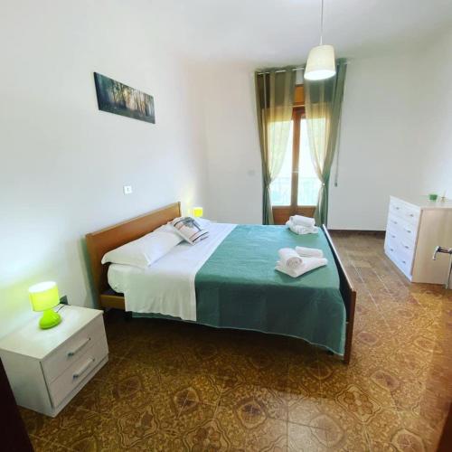 a bedroom with a bed and a dresser and a window at Soleado Apartments Caprioli-Palinuro in Palinuro