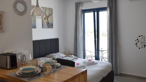 a bedroom with a bed and a table with dishes on it at 4Bro Rooms Laerma Village in Láerma