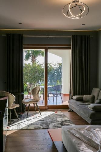 a living room with a couch and a table and chairs at Villa Kristiano 21 in Sarandë