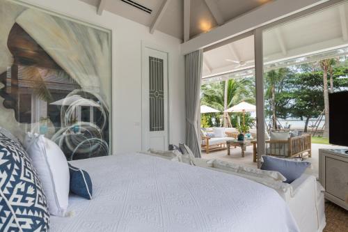a bedroom with a white bed and a large window at Mia Palm, beach villa and events in Bophut 