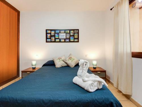 a bedroom with a bed with a white dog on it at Casa Aloe in Corralejo