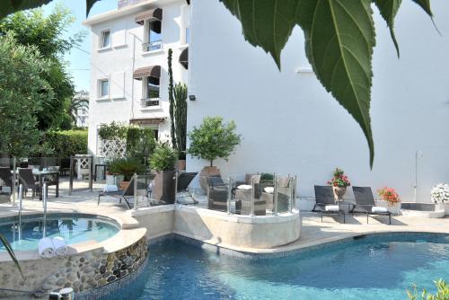 uma piscina em frente a um edifício em Hôtel La Villa Cannes em Cannes