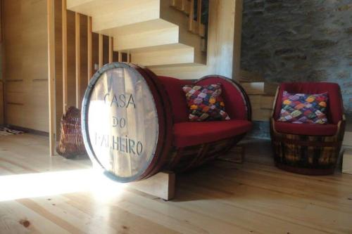 a living room with a barrel couch and a chair at Casa do Palheiro in Miranda do Douro