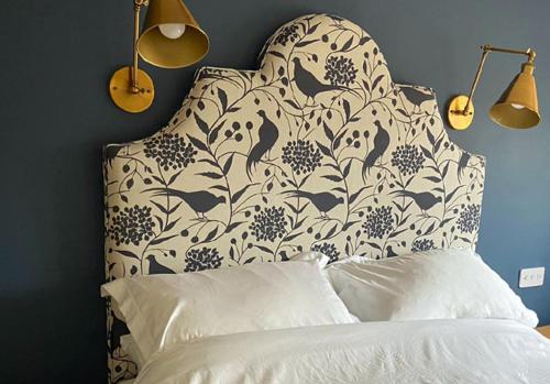 a bedroom with a bed with a floral headboard at Rowley Farm Holidays in Worcester