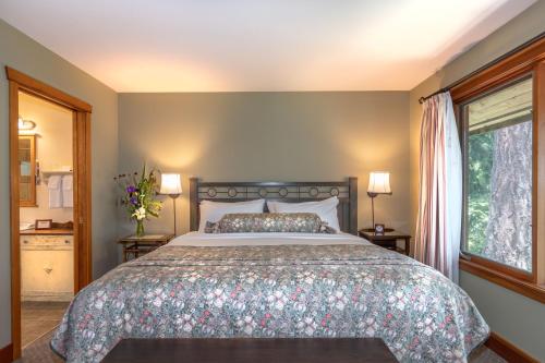 a bedroom with a large bed and a window at Hastings House Country House Hotel in Ganges