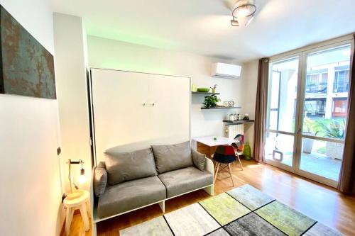a living room with a couch and a table at Spa Tiny Love Apartment close to Milan-Como-Malpensa in Saronno