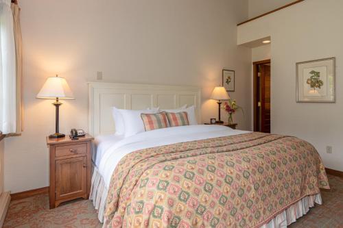 a bedroom with a large bed and two lamps at Hastings House Country House Hotel in Ganges