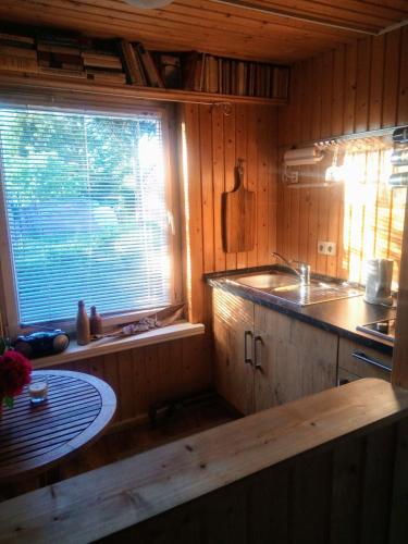 a kitchen with a sink and a window in it at Auszeit in Friedland