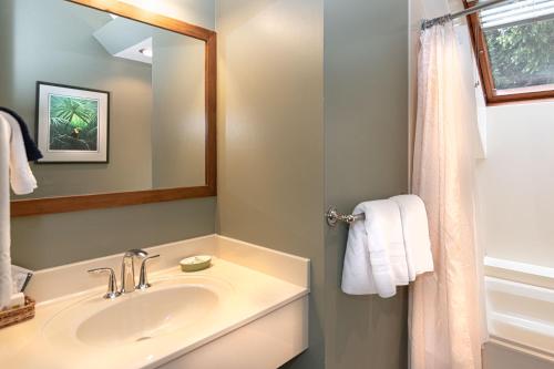 a bathroom with a sink and a mirror at Hastings House Country House Hotel in Ganges