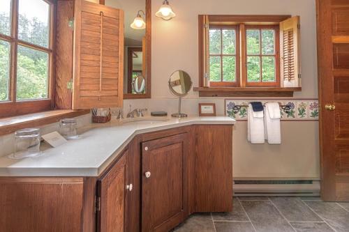 a bathroom with a sink and a mirror at Hastings House Country House Hotel in Ganges